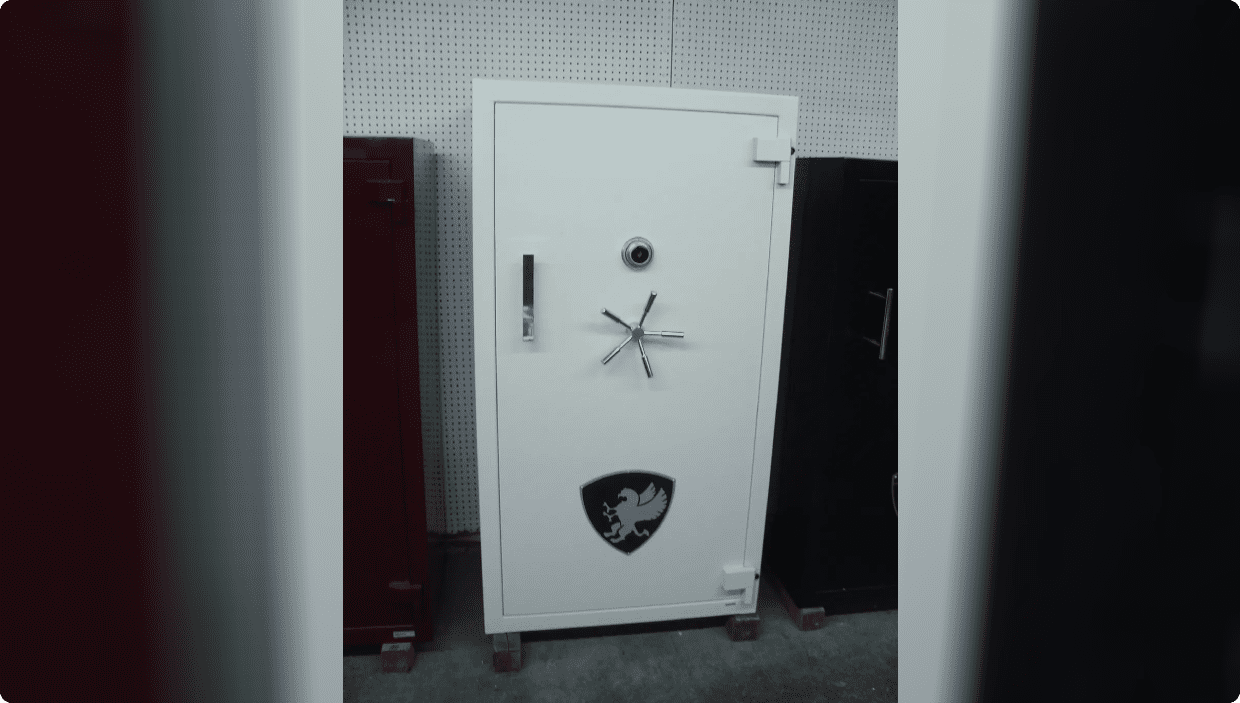 A large white safe with a combination lock and emblem on the door.
